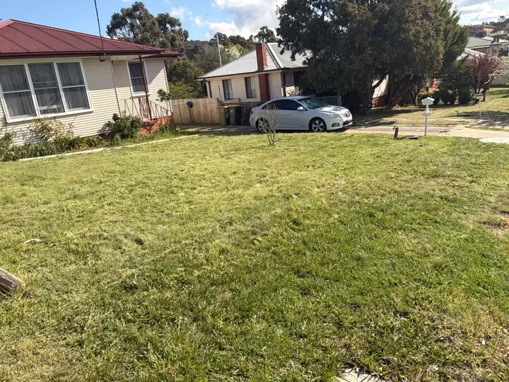 After: front lawn mown short and even
