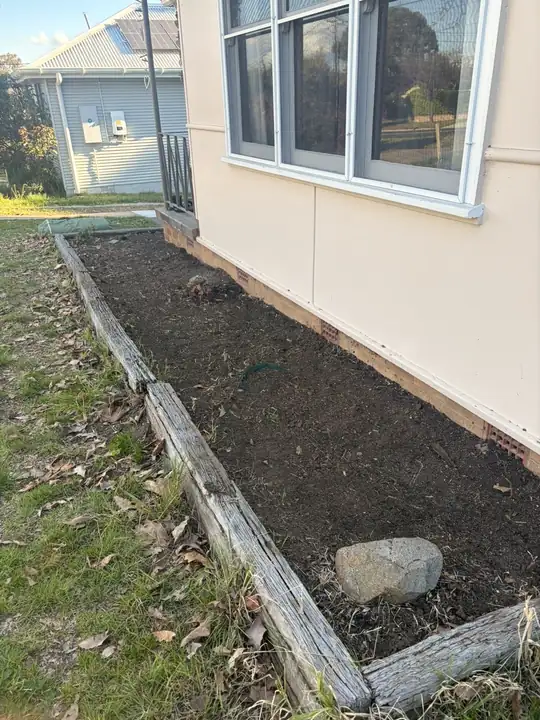 After: garden bed beside the house cleared and edged