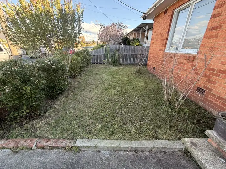 After: side garden cut back and opened up beside a brick house